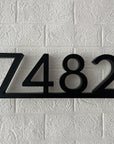Side view of 3D floating address numbers showing spacers and light depth