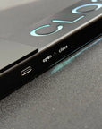 Close-up of a device with 'open' and 'close' labels on a dark surface