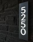 Custom LED house number sign 6514 featuring a floating vertical design and warm backlighting