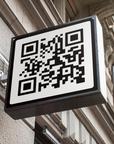 QR code on a signboard attached to an architectural wall