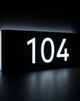 Custom metal backlit house address plaque in matte black with bright LED illumination