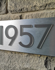 Modern curb appeal upgrade featuring illuminated 3D house numbers on dark siding