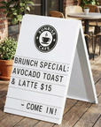 White metal sandwich board displaying brunch menu specials for cafe sidewalk