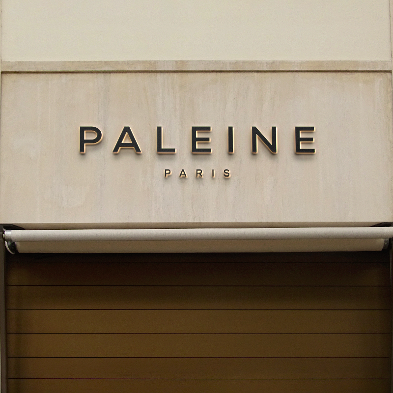 Backlit LED channel letter signage with the word &#39;PALENE&#39; in a storefront setting.