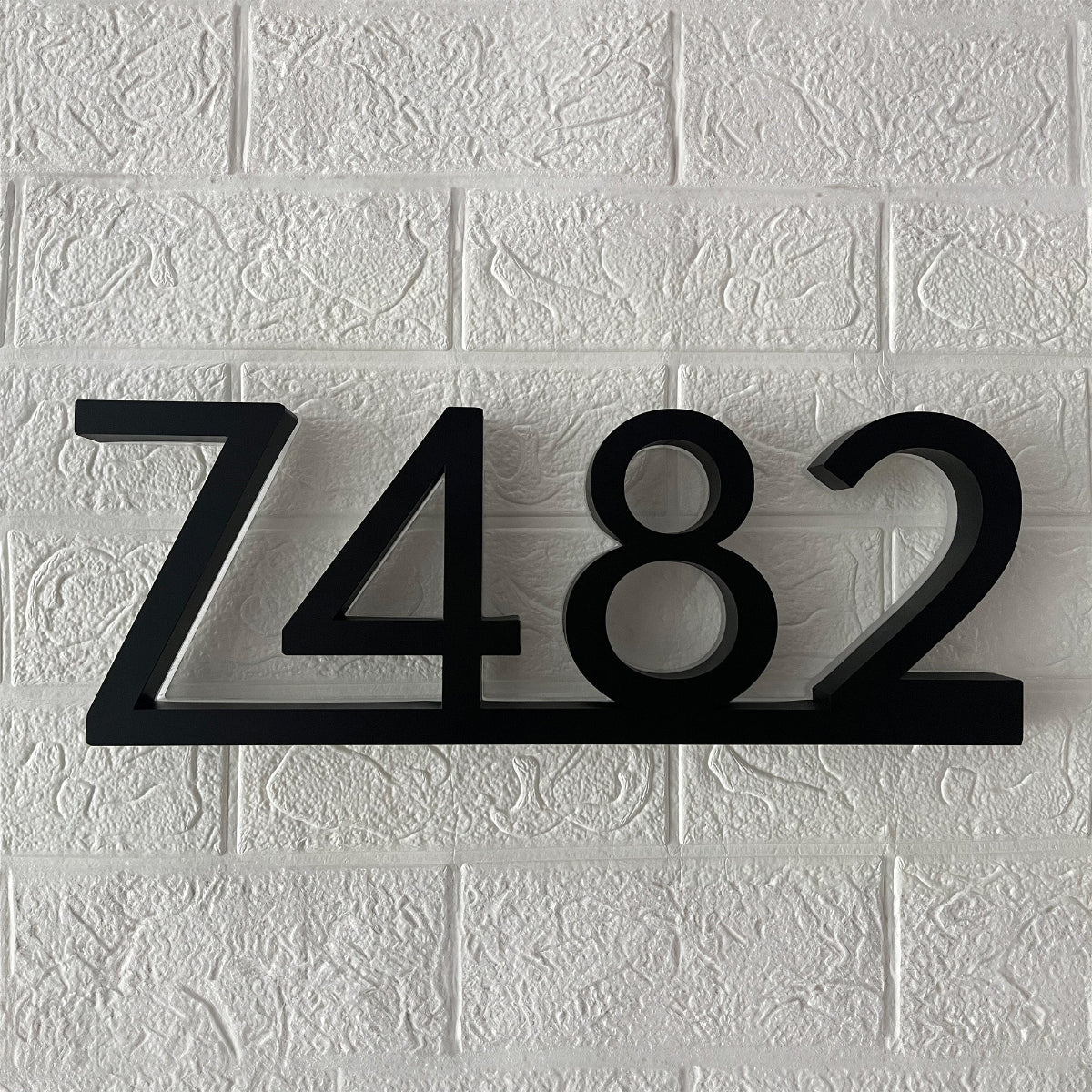 Side view of 3D floating address numbers showing spacers and light depth