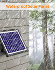 Waterproof solar panel attached to a wall with a background of trees in the rain.