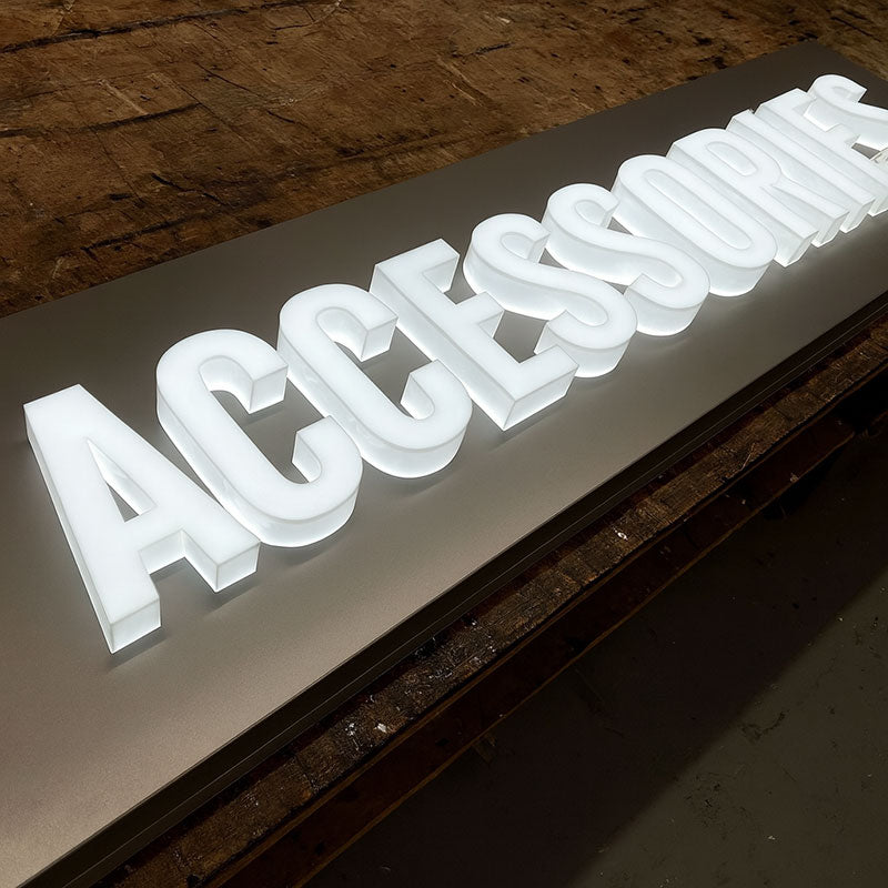 Full lit acrylic letters mounted on a brushed metal backer panel
