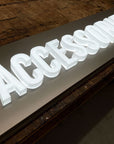 Full lit acrylic letters mounted on a brushed metal backer panel