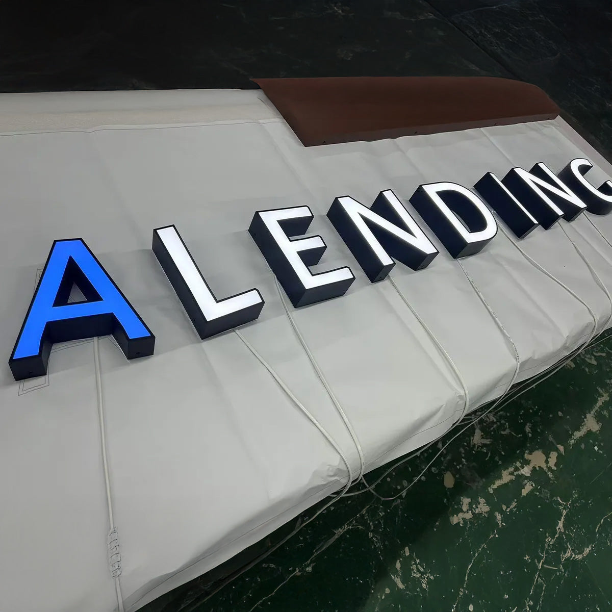 Blue acrylic front lit channel letters with stainless steel silver trim for office building