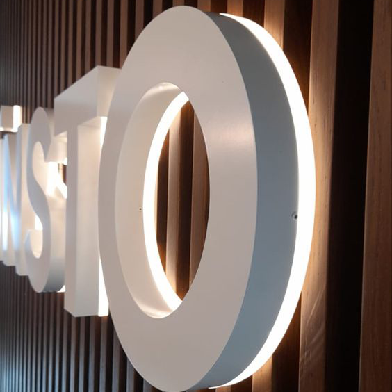 Custom font LED channel letters in white finish for commercial building facades.