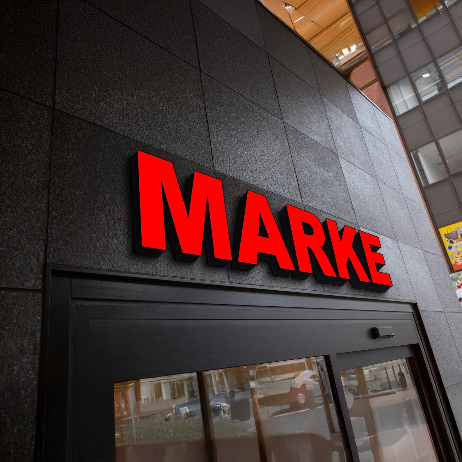 Illuminated 3D channel letter sign reading MARKET with red acrylic face and black sides