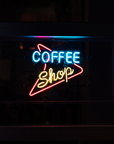 Custom LED neon coffee shop sign hanging in window for cafe branding