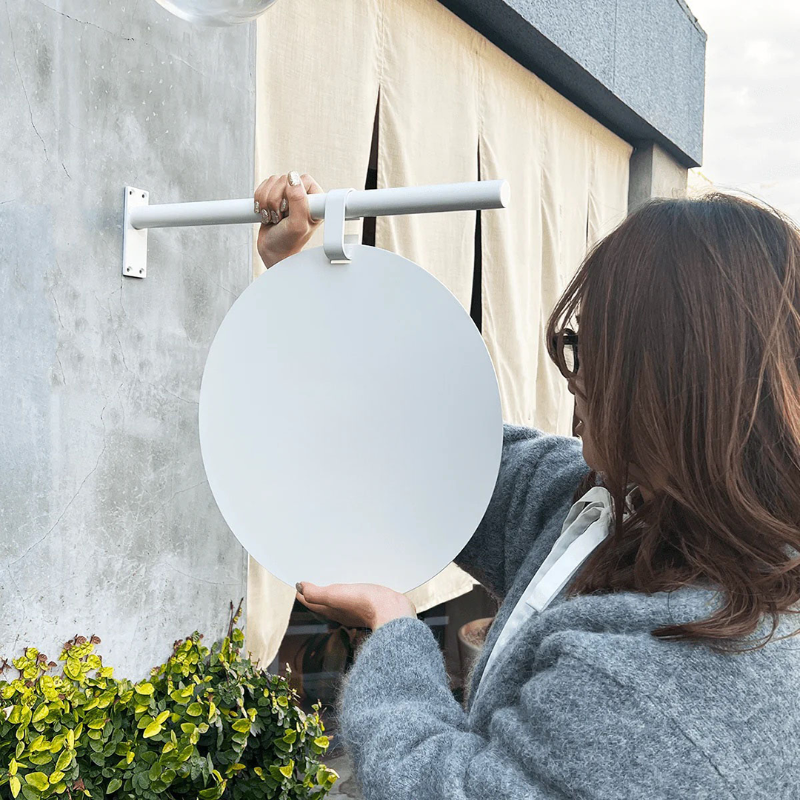 Side profile view of double sided business sign showing sturdy metal construction