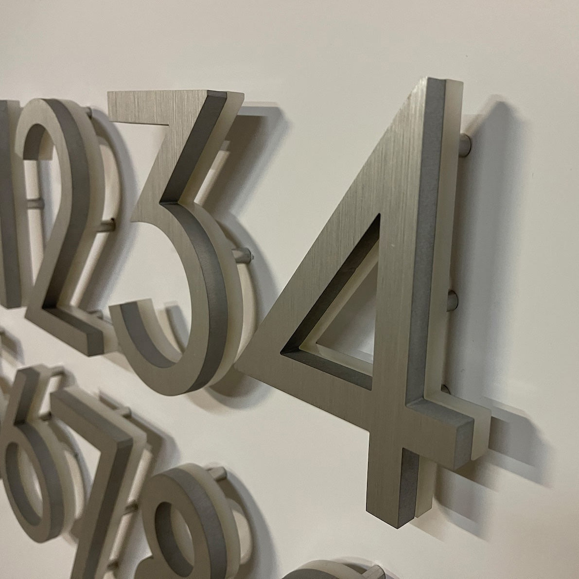 3D floating mount backlit numbers with stainless steel spacers