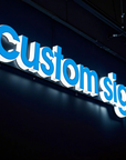 Custom illuminated acrylic letters glowing across the face and sides