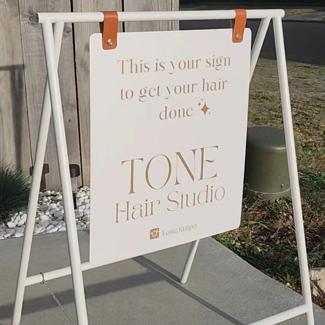 A-frame marketing sign for hair salons featuring custom promotional text