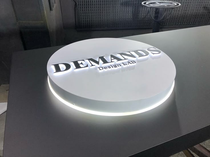 Halo lit 3D logo sign creating a floating effect on interior walls