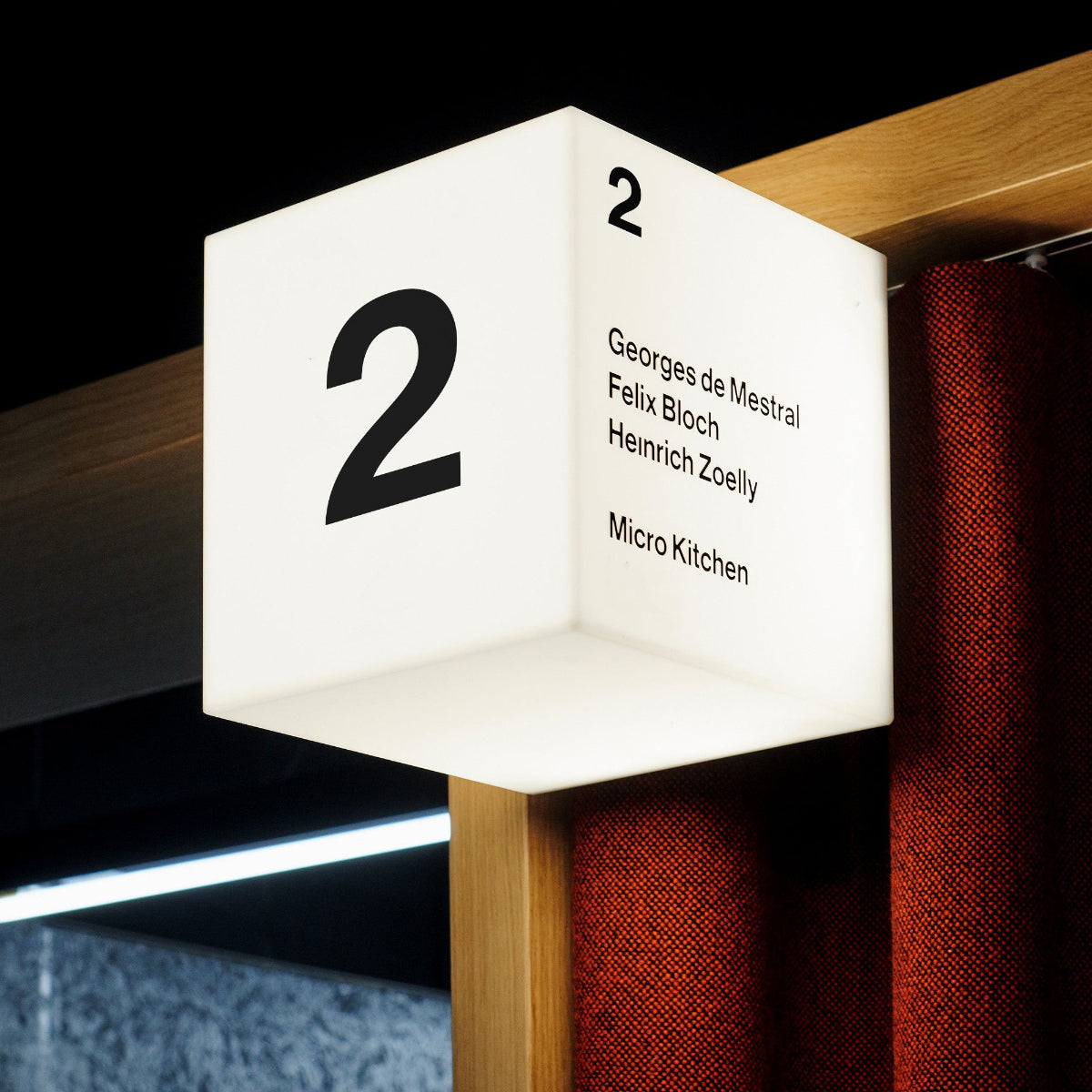 Illuminated square logo box featuring custom vinyl graphic application