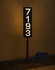 Solar-powered address sign with numbers '7193' on a dark background