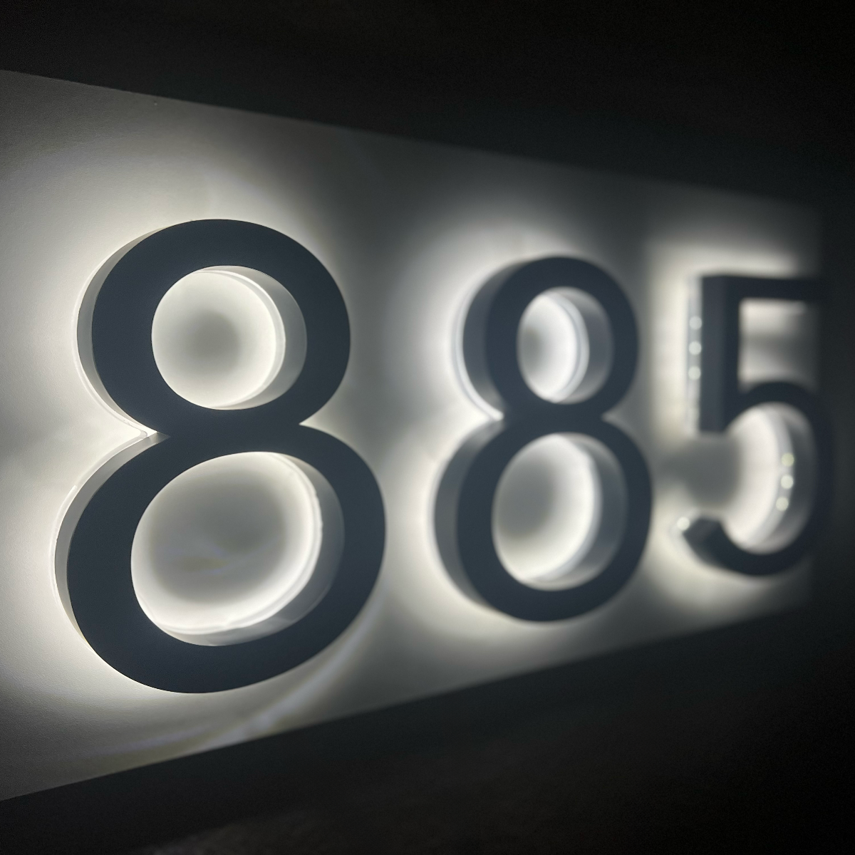 LED house address sign 885 glowing brightly at night for emergency responders