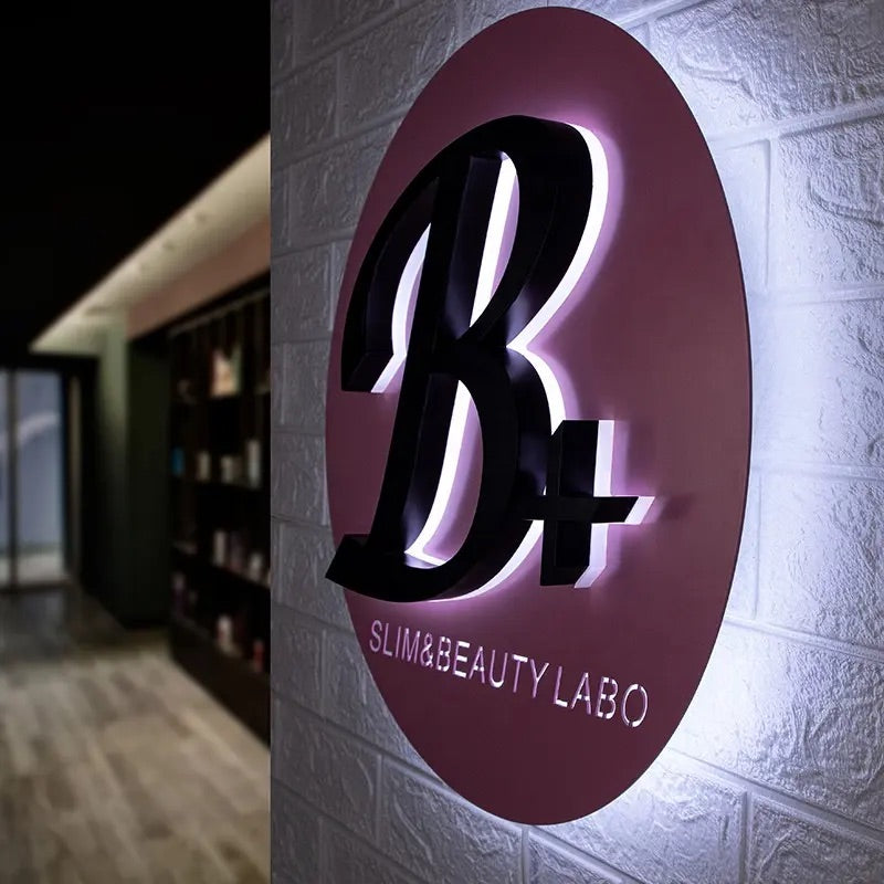 Luxury salon branding sign with gold finish and soft halo lighting