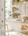 White Open / Closed slider sign mounted on a bright boutique storefront door