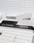 Open / Closed slider sign shown in matte white and matte black variants