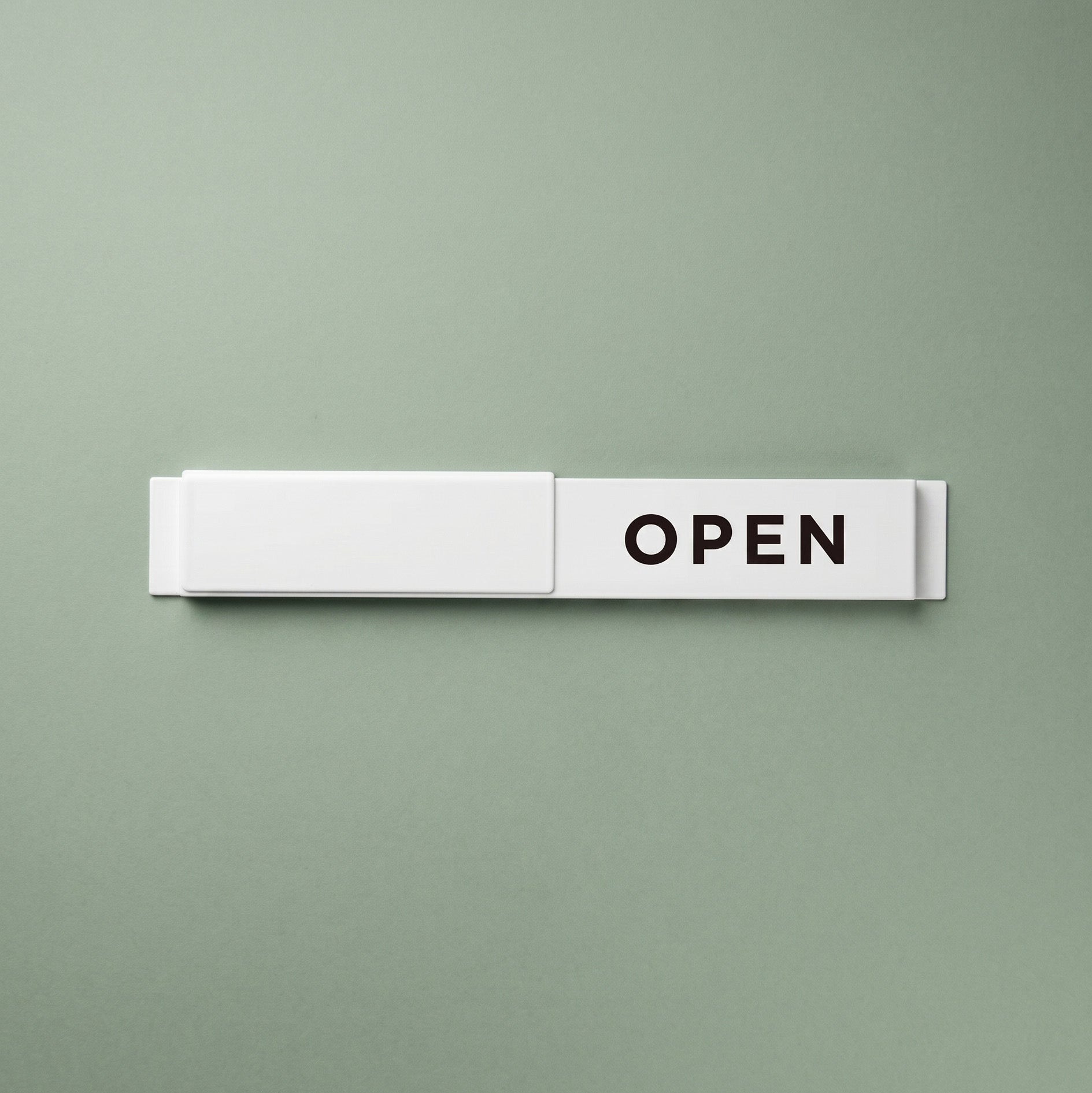 White and black Open / Closed slider signs stacked side by side