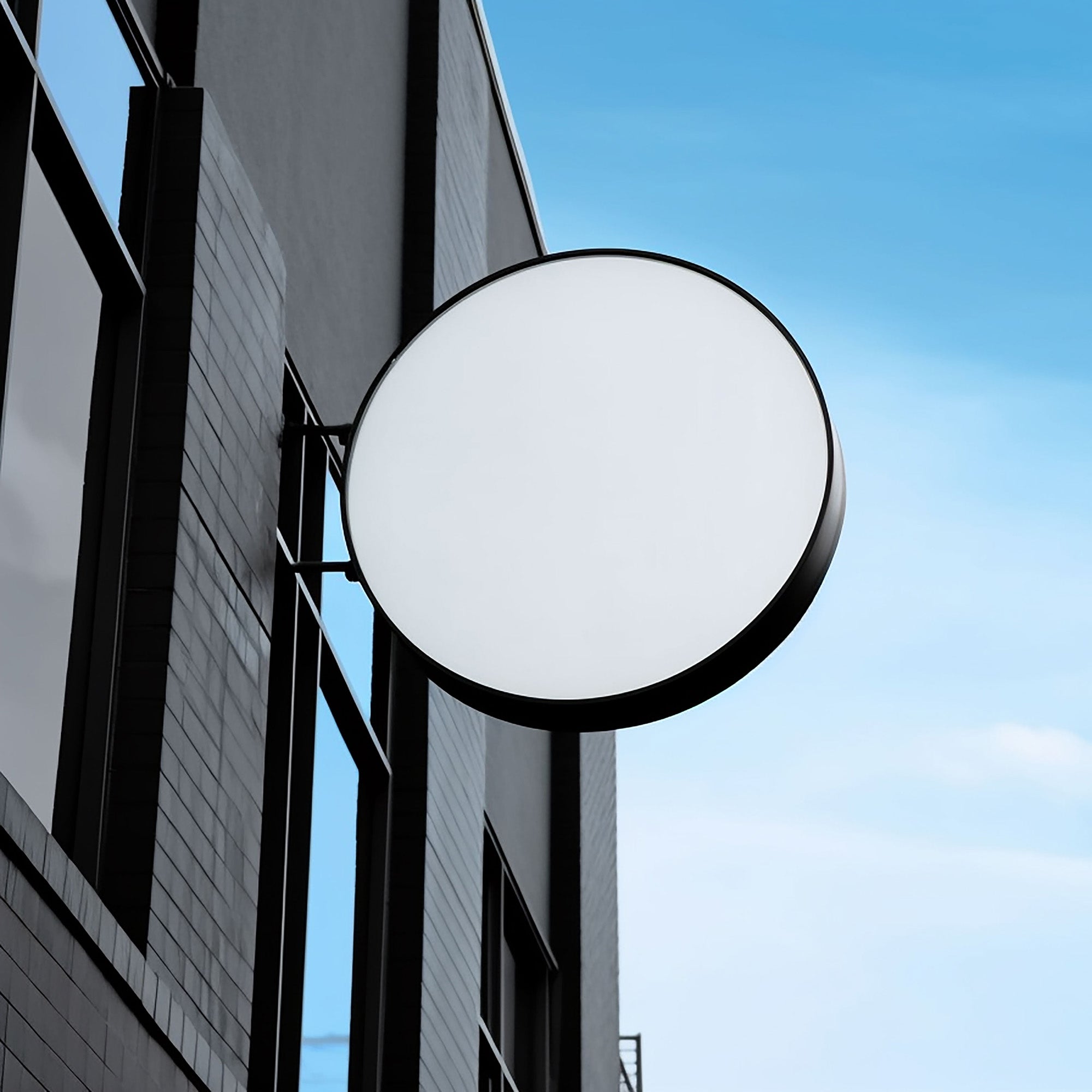 Custom round double sided light box with brushed stainless steel frame and acrylic face