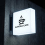 Storefront projecting light box sign for cafe visibility