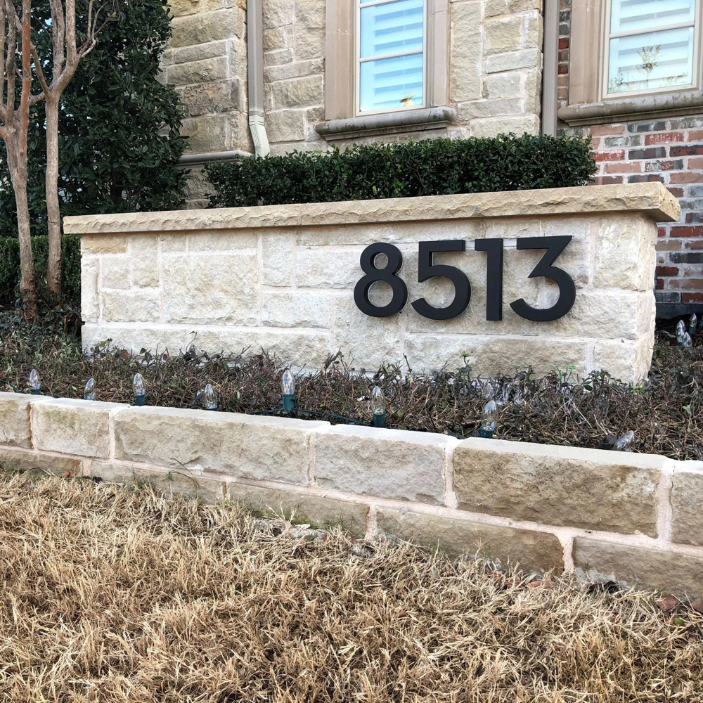 LED house numbers mounted on stucco wall with hidden hardware