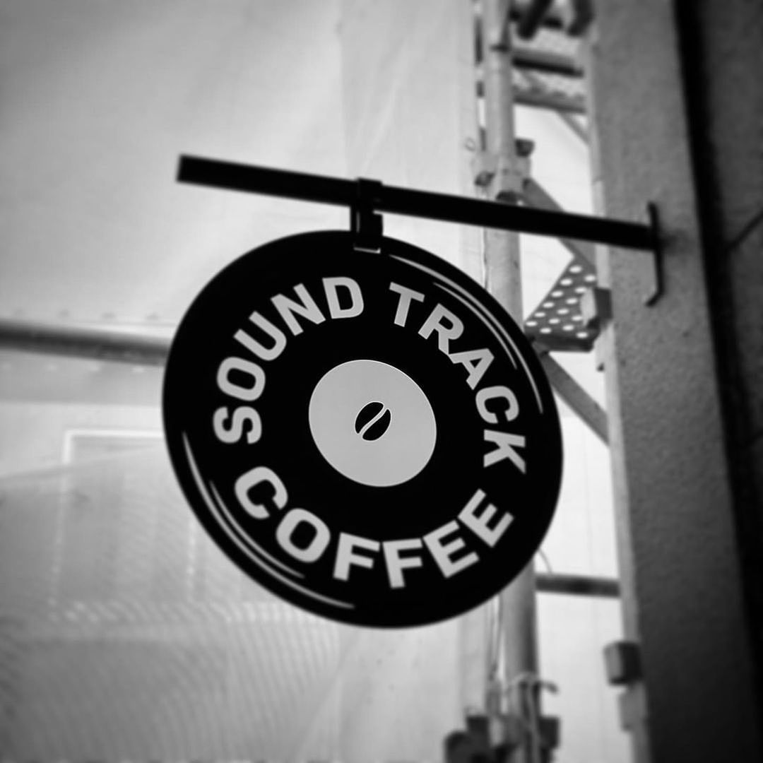 Weather resistant outdoor hanging signage designed to withstand wind and rain