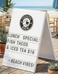 Outdoor cafe with a sign advertising lunch specials on a beach setting