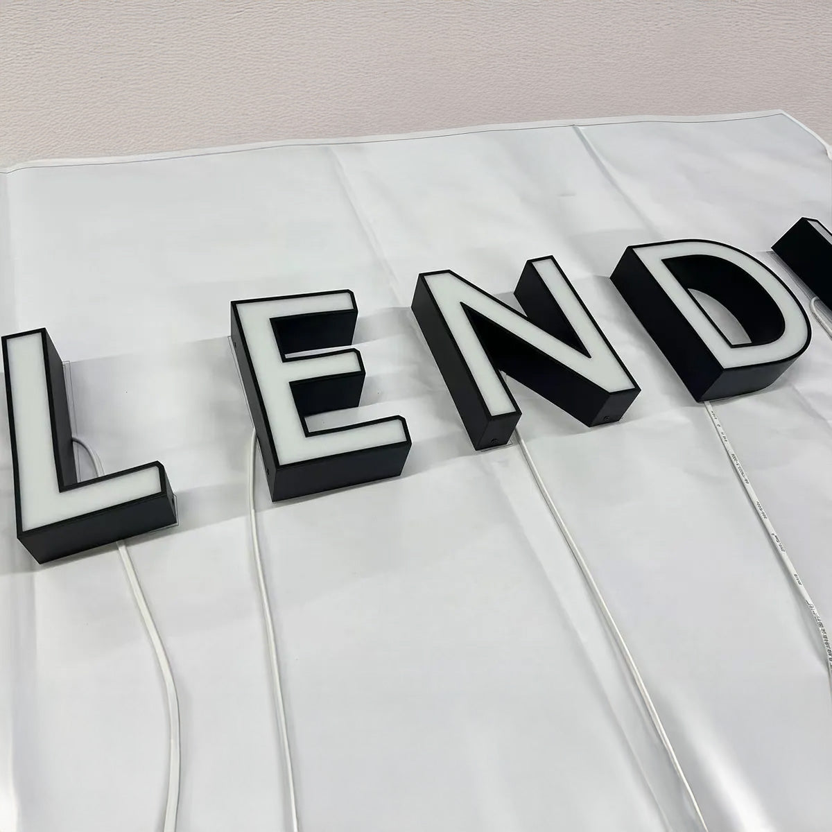 White face LED channel letters with contrasting black sides illuminated at night